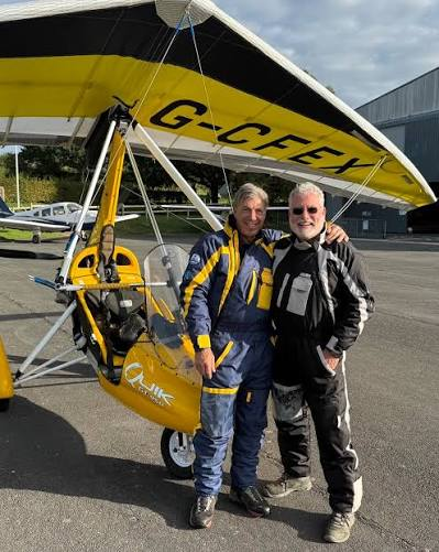 Yellow Quik flexwing G-CFEX with two pilots